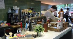 Waiter standing behind a counter at social enterprise Open Kitchen