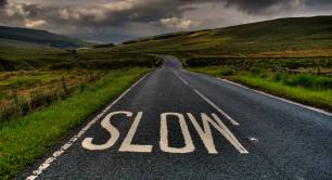 Slow sign on country road